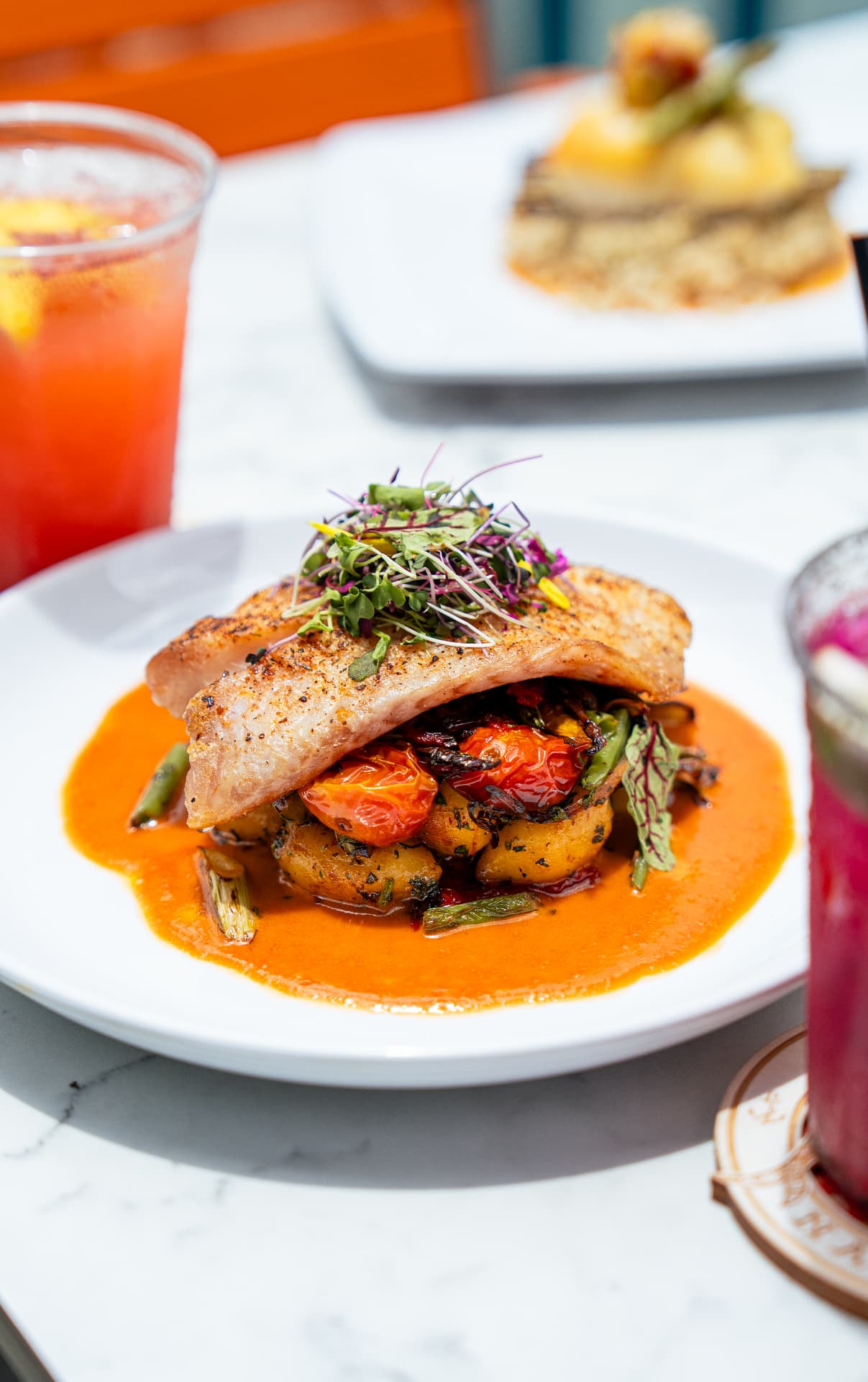 Plated seared local fish photographed in natural light for a Naples restaurant