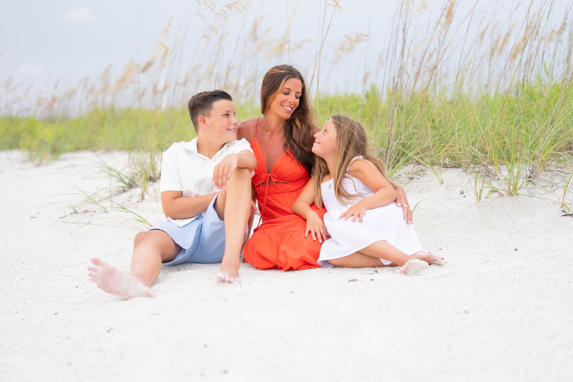 Extended family portrait on the white sand at sunset